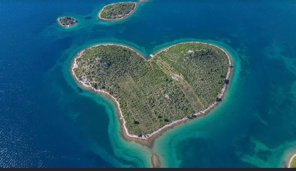 Aerial photograph of Galešnjak, the naturally heart-shaped island, turquoise sea all around