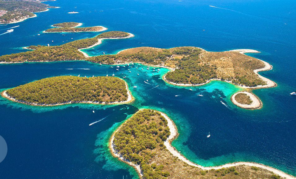 Pakleni islands near Hvar from the air, boats threading between green islets